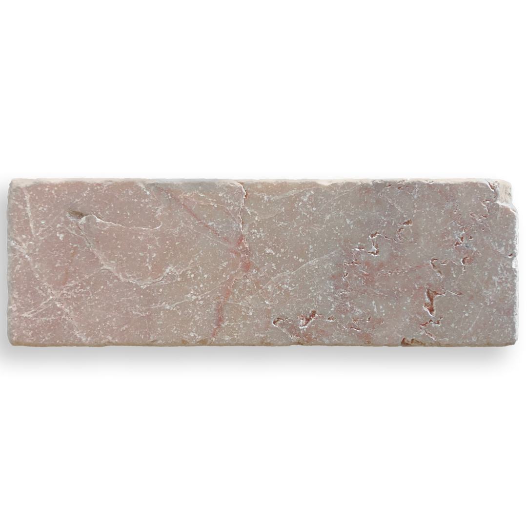 A rectangular pinkish-gray stone tile with natural marble-like veining, shown on a plain white background.