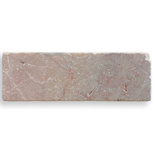 A rectangular pinkish-gray stone tile with natural marble-like veining, shown on a plain white background.
